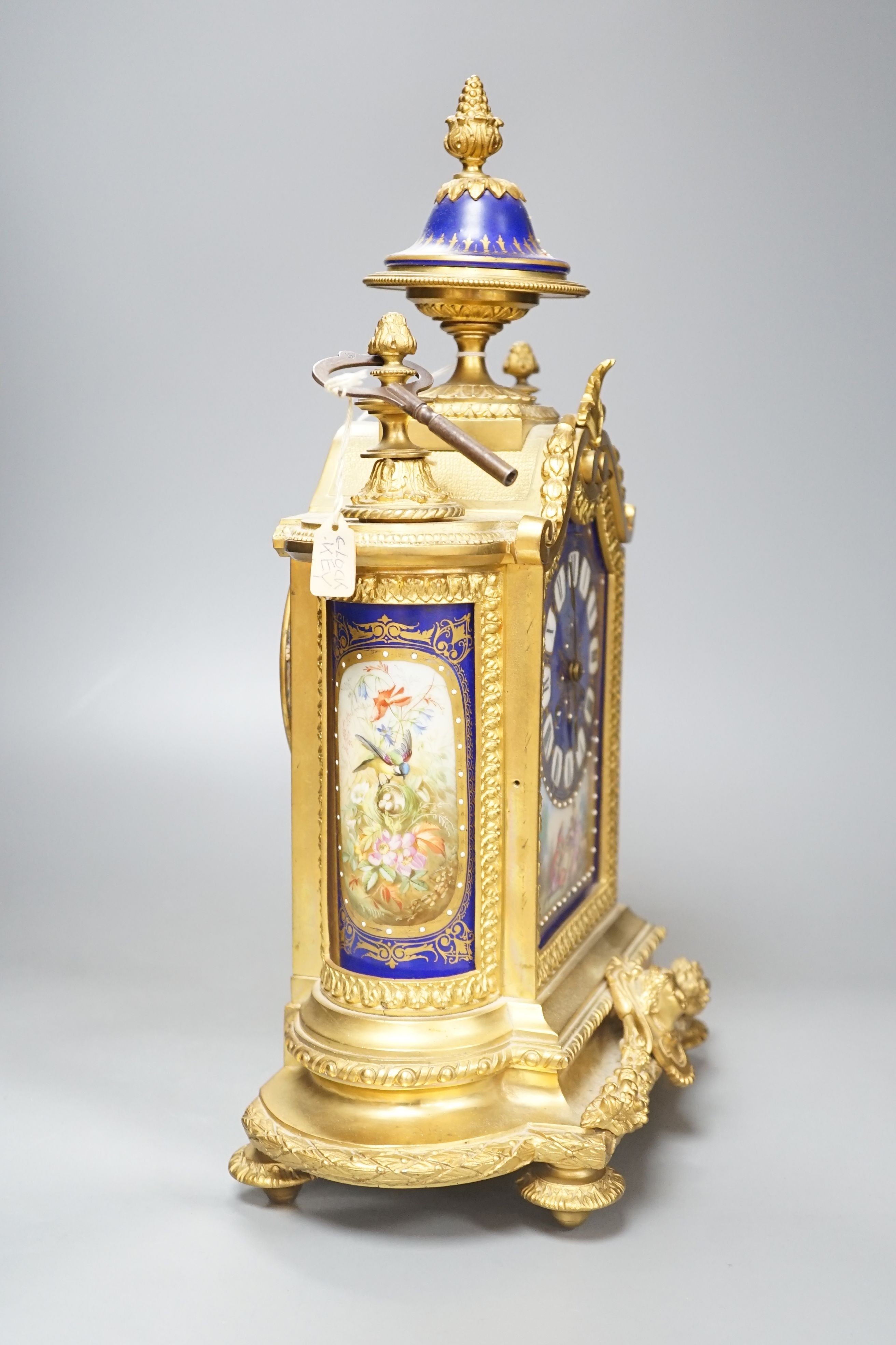 A 19th century French ormolu cased mantel clock, with decorated porcelain panels and face, eight day movement with strike, 40cm high